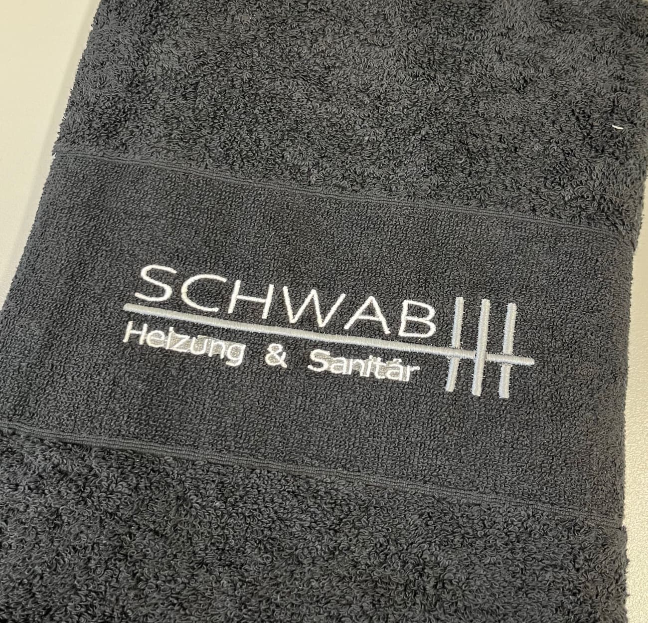 Besticktes Handtuch mit einem Firmenlogo